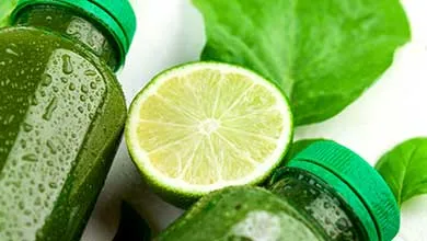 Green juice bottle with a lime and leaf surrounding it